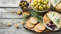 Gourmet Delights: A Tempting Display of Cheesy Goodness, Grapes, Crackers, and Olives Adorned with F