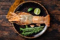 Gourmet dinner with Spiny lobster or sea crayfish on a plate. Wooden background. Top view Royalty Free Stock Photo