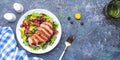 Gourmet duck salad with grilled breast with red orange, kumquat, blueberry and swiss chard, lettuce and arugula leaves on blue Royalty Free Stock Photo