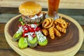 Gourmet Grilled burger with bacon and gorgonzola cheese on a brioche bun with beer Royalty Free Stock Photo