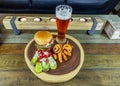 Gourmet Grilled burger with bacon and gorgonzola cheese on a brioche bun with beer Royalty Free Stock Photo