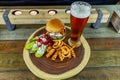 Gourmet Grilled burger with bacon and gorgonzola cheese on a brioche bun with beer Royalty Free Stock Photo