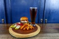 Gourmet Grilled burger with bacon and gorgonzola cheese on a brioche bun with beer Royalty Free Stock Photo