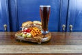 Gourmet Grilled burger with bacon and gorgonzola cheese on a brioche bun with beer Royalty Free Stock Photo