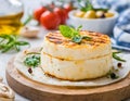 A gourmet grilled cheese wheel, garnished with herbs, ready for a delightful meal