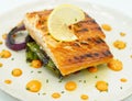 Gourmet grilled Norwegian salmon loin on a mattress of vegetables Royalty Free Stock Photo