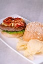 Gourmet kimchi angus beef burger with potato chips on the side Royalty Free Stock Photo