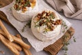 Brie or camembert cheese with thyme, nuts, honey and grissini breadstick Royalty Free Stock Photo