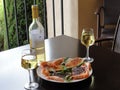A gourmet meal, white wine, salmon, prawns