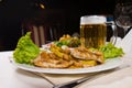 Gourmet Meaty Main Dish with Beer Mug Served Royalty Free Stock Photo