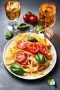 Gourmet Pasta with Ripe Tomatoes, Fresh Basil, and White Wine for a Romantic Dinner Experience Royalty Free Stock Photo