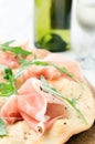 Gourmet pizza with proscuitto and wine Royalty Free Stock Photo