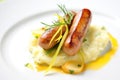 gourmet plating of bangers and mash with chives