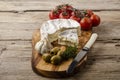 Gourmet platter with camembert, cherry tomatoes and olives