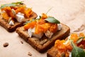 Gourmet pumpkin toast with feta and fresh herbs on a whole grain slice. Rustic food Royalty Free Stock Photo