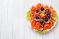 Gourmet restaurant serving a plate of smoked salt, raw white fish fillets and salmon. Delicacy fresh seafood dish with catfish, Royalty Free Stock Photo