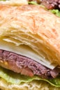 Gourmet roast beef sandwich on croissant Royalty Free Stock Photo