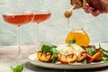 Gourmet Roasted Peaches with Burrata soft cheese, basil and drizzled with honey, with rose wine. Antipasto Dinner or aperitivo