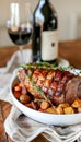 Gourmet Roasted Pork Loin with Vegetables and Red Wine on Wooden Table