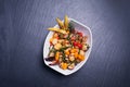 Gourmet salad on black stone background. Dark food photography