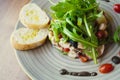 Gourmet salad on black stone background. Dark food photography