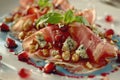Gourmet salad with prosciutto, blue cheese, walnuts, and pomegranate on artistic plate