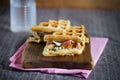 Gourmet sandwich of waffles, prosciutto, cheese and mushrooms