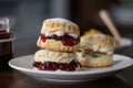 gourmet scone tower with strawberry preserves, clotted cream and sprinkles