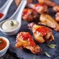 Flavor Fusion: Fried Chicken Wings with Seasonings and Sauces, Captured on Black Slate