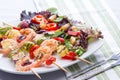 Gourmet shrimp skewers with salad greens
