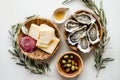 Gourmet spread with oysters, cheese, olives, and honey in rustic setting Royalty Free Stock Photo