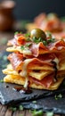 Gourmet stack: cured meat, cheese, and olives on crispy crackers Royalty Free Stock Photo