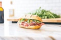 gourmet sub with rare roast beef, arugula, on marble Royalty Free Stock Photo