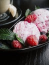 Gourmet summer dessert of craft ice cream made with fresh berries, cherry, mint on dark wooden background Royalty Free Stock Photo