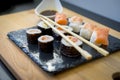Gourmet, Sushi on a wooden table on black slate plate with soy s