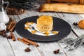 Gourmet decorated honey cake on a black plate