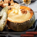 Gourmet Swiss cheese fondue served in a pumpkin