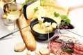 Gourmet Swiss fondue dinner on a winter evening with assorted ch Royalty Free Stock Photo
