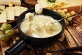 Gourmet Swiss fondue dinner on a winter evening with assorted ch Royalty Free Stock Photo