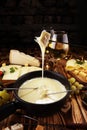 Gourmet Swiss fondue dinner on a winter evening with assorted ch Royalty Free Stock Photo