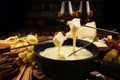 Gourmet Swiss fondue dinner on a winter evening with assorted ch Royalty Free Stock Photo