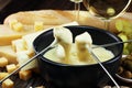 Gourmet Swiss fondue dinner on a winter evening with assorted ch Royalty Free Stock Photo