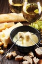 Gourmet Swiss fondue dinner on a winter evening with assorted ch Royalty Free Stock Photo