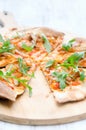 Gourmet thin crust pizza with fresh rocket and caramelised onion