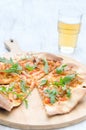 Gourmet thin crust pizza with fresh rocket and caramelised onion