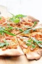 Gourmet thin crust pizza with fresh rocket and caramelised onion