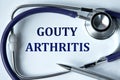 GOUTY ARTHRITIS - words on white background with pen and stethoscope