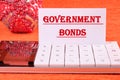 Government Bonds text on a white business card on a calculator on an orange background Royalty Free Stock Photo