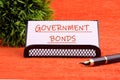 Government Bonds text on a white card on a stand on an orange background Royalty Free Stock Photo