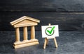 Government building a green vote tick. Implementation of the new law. The legitimacy of the government, an honestly elected Royalty Free Stock Photo